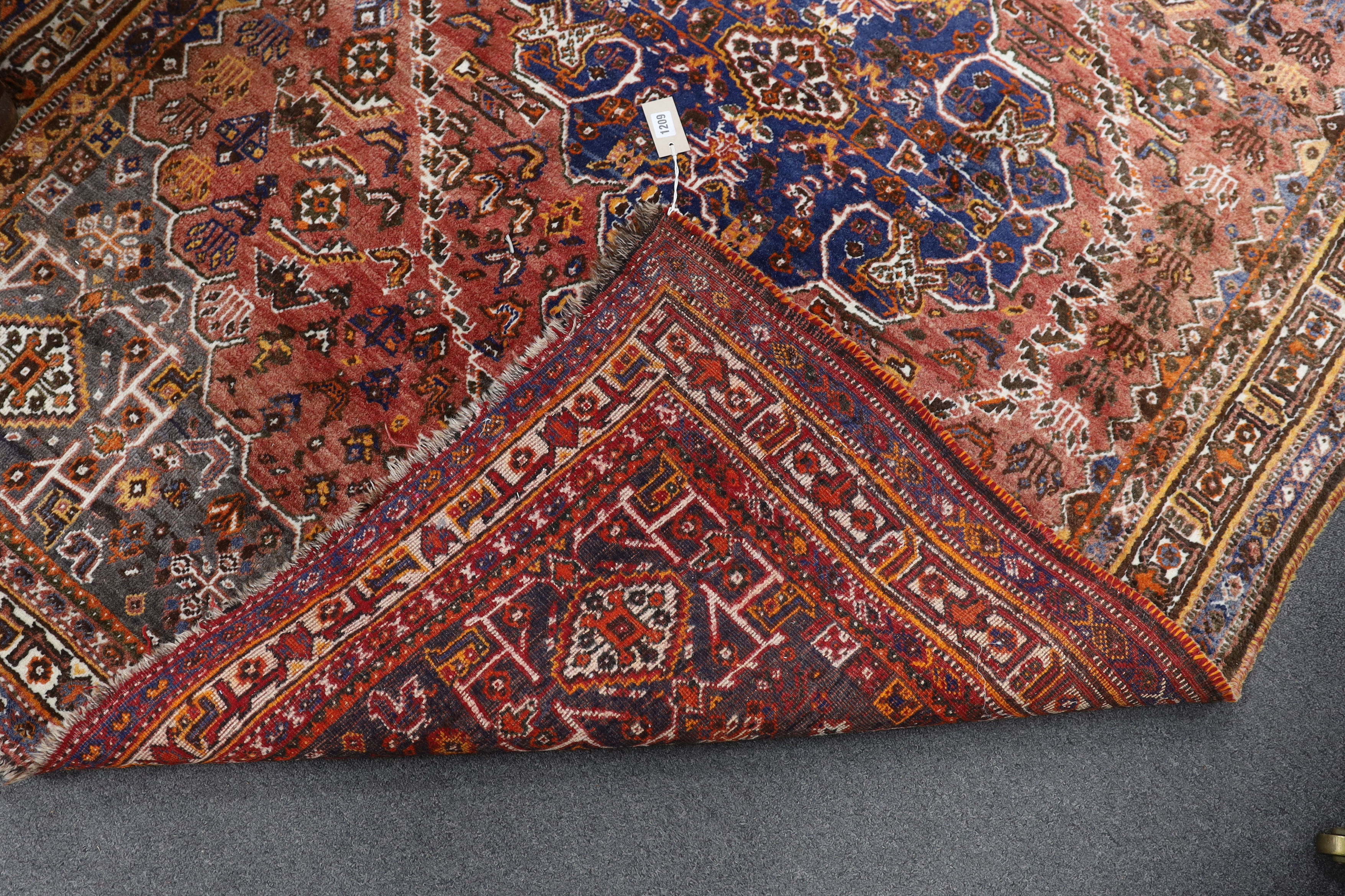 A North West Persian red ground rug, 214 x 156cm
